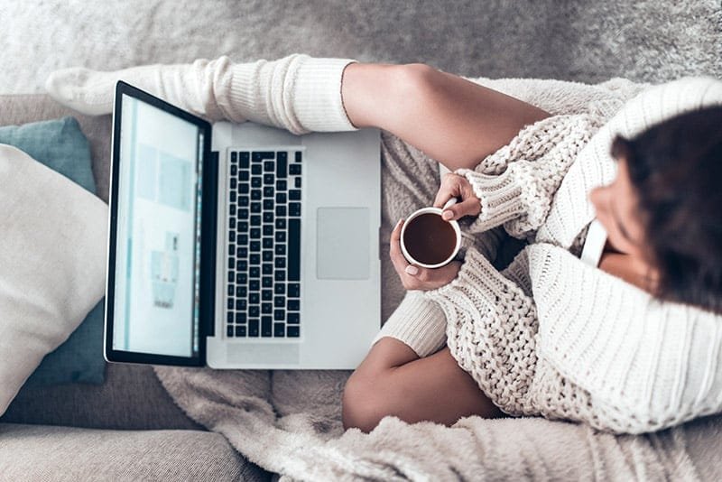 Young woman writing on laptop sexy