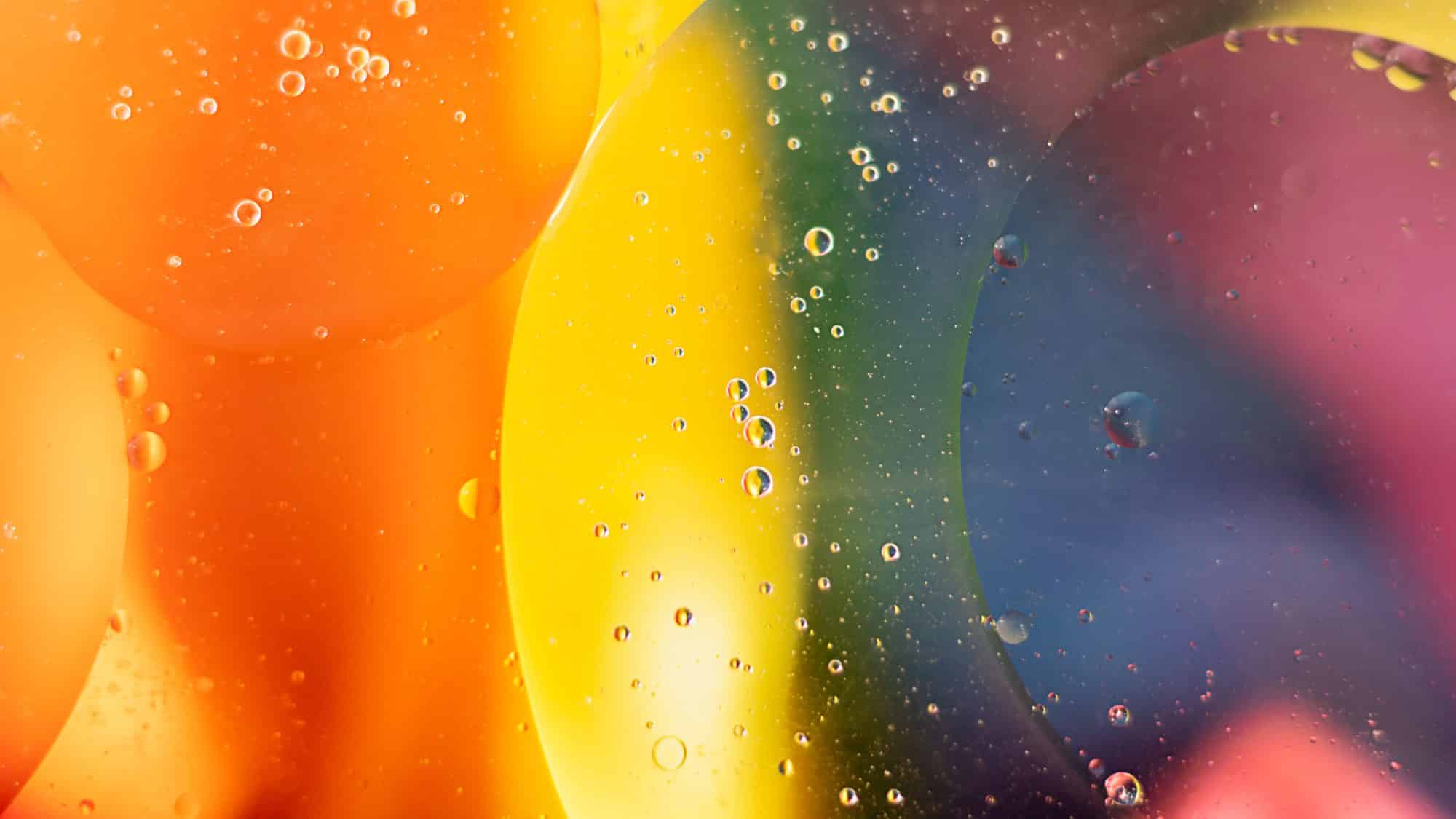 Fantastic structure of colorful oil bubbles. Chaotic motion. Abstract paint. Rainbow, LGBT