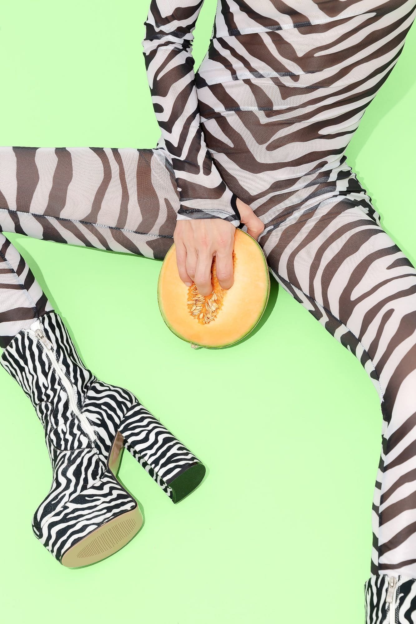 Plaufyl Girl in sexy clothes zebra print with fresh melon between legs. Tropically e