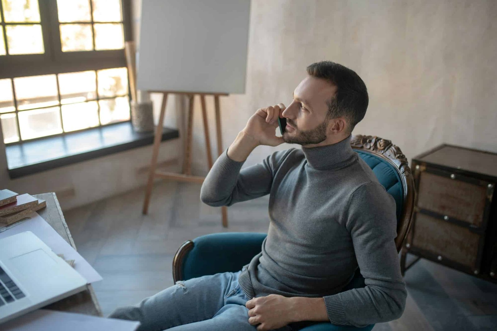 Bearded businessman speaking on the phone with wife