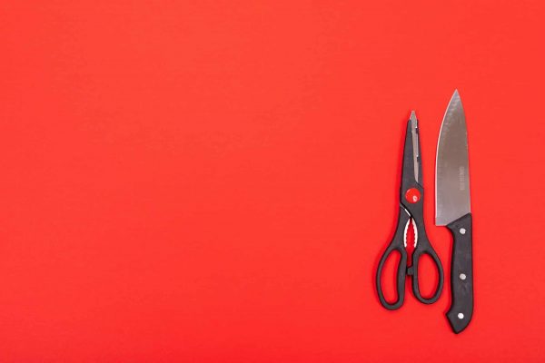 Knife and scissors are isolated on a red background